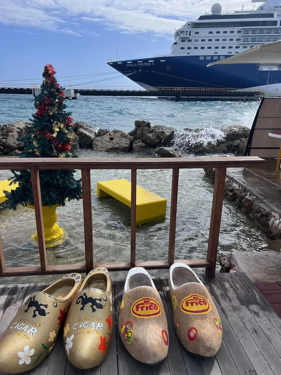 Decorated Dutch clogs with Marella Explorer 2 cruise ship and Christmas tree at Curacao port